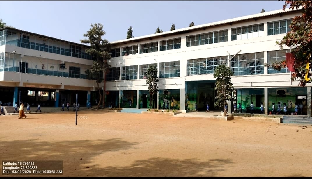 Manjushree English School main building on a daytime view of the campus playground