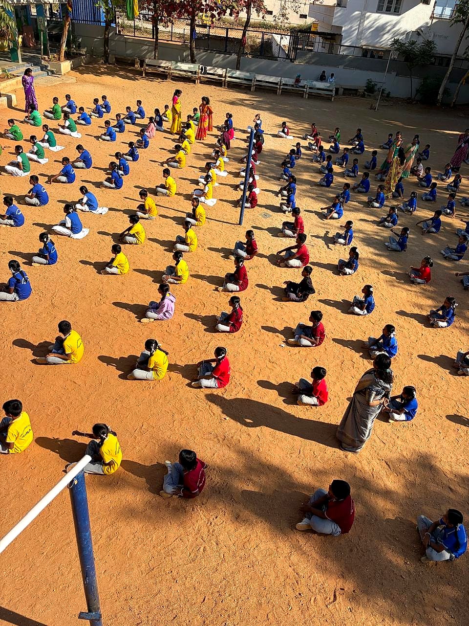 Full school assembly seated on the school ground during Sports Week